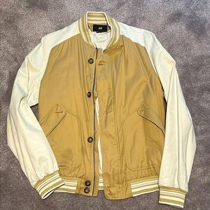 This H&M size medium jacket blends a classic varsity style with a modern twist.